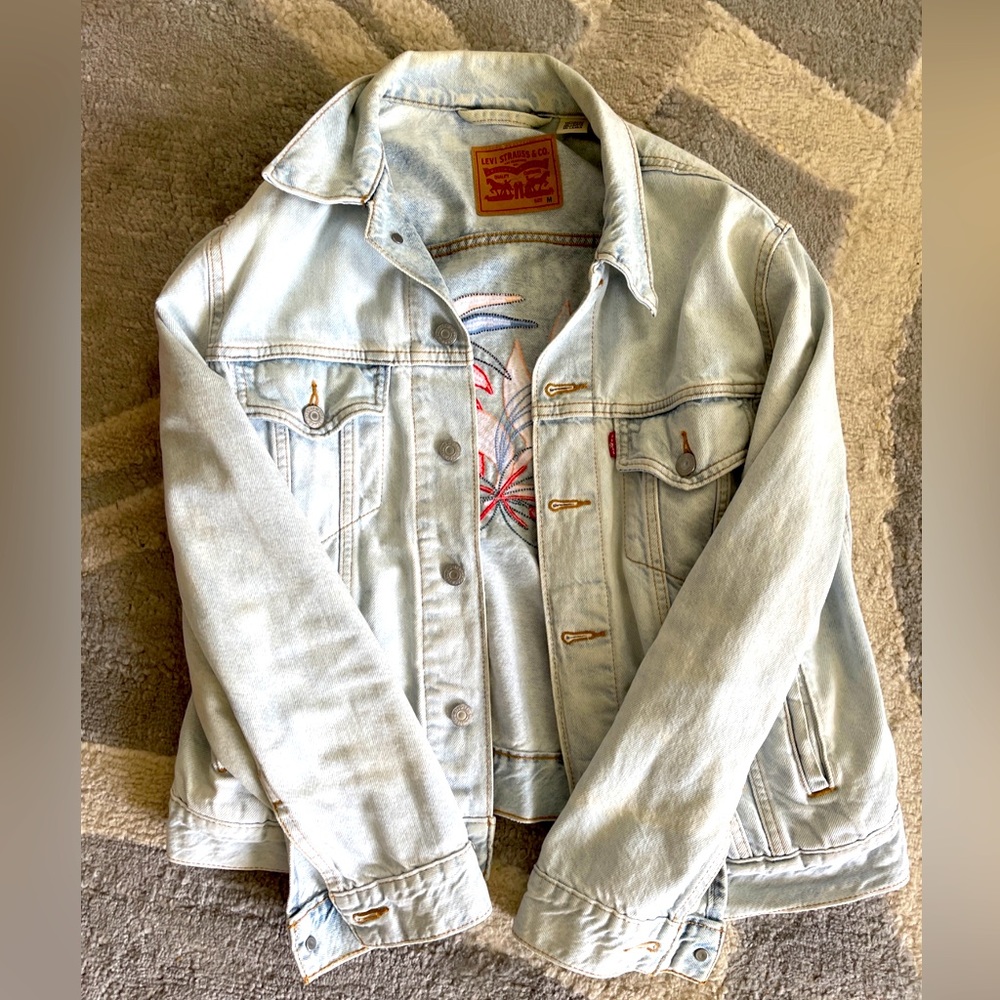 Women’s Levi’s jean jacket with floral embroidery on the back size M